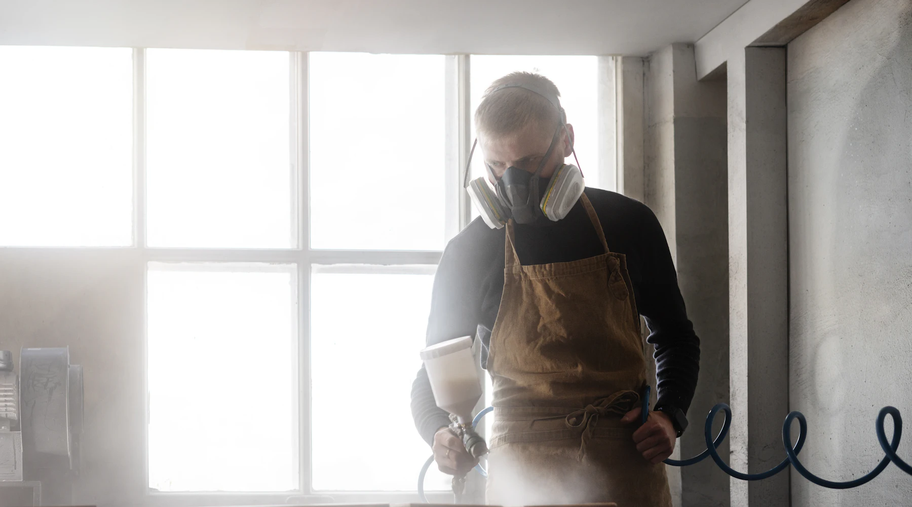 Duct cleaning technician in a respirator