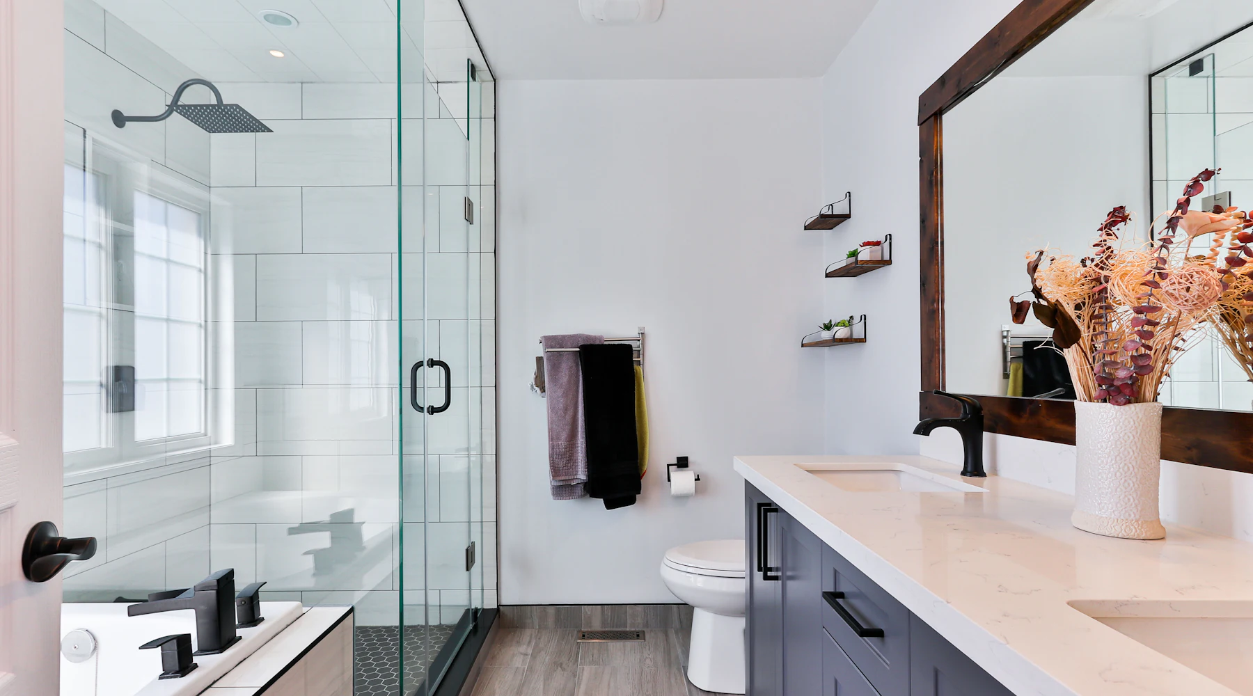 Modern remodeled bathroom with tile shower and vanity