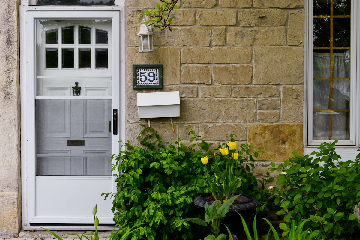 White front door with a house number