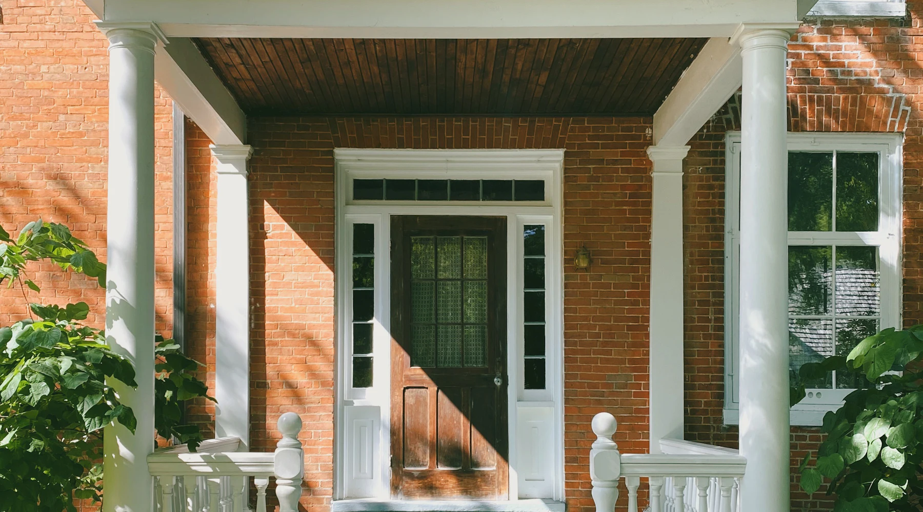 Brick home with a new white front entry door