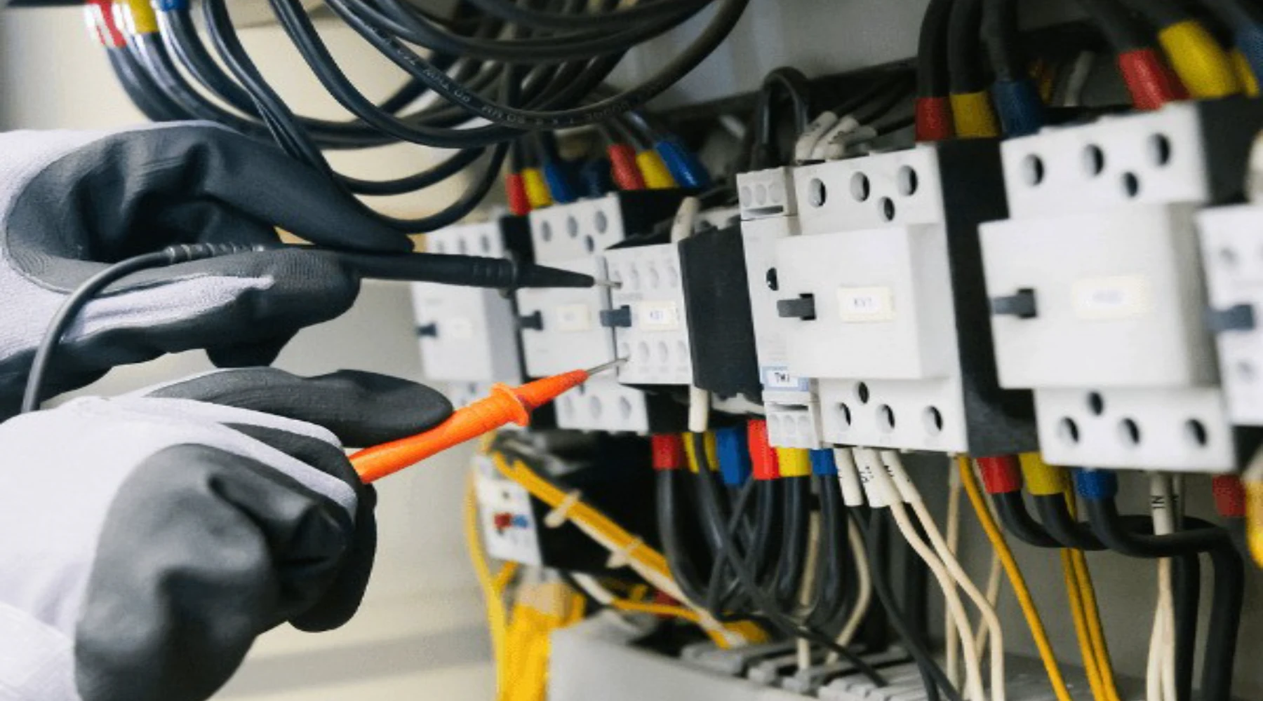 Electrician testing an electrical panel