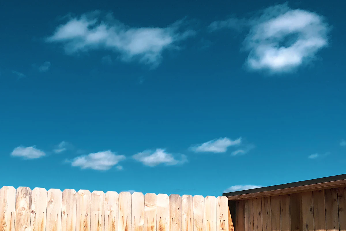 New wood privacy fence under a blue sky