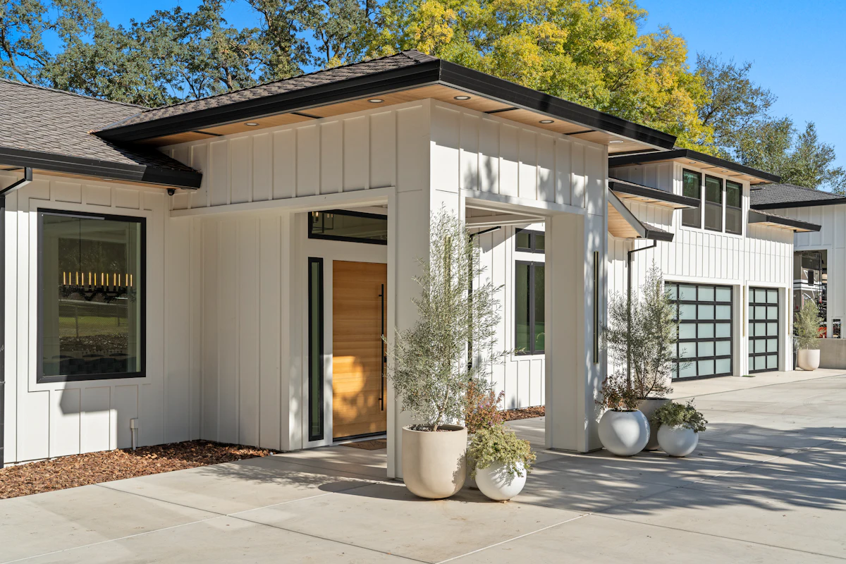 Glass-panel garage doors on a white home