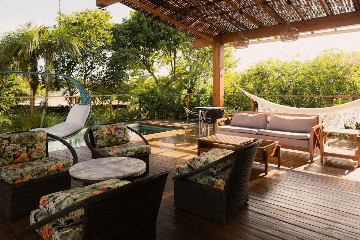 Covered patio with seating and a pool view