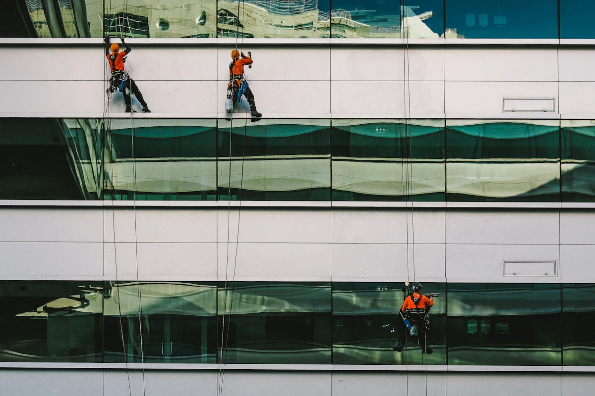 Window cleaner washing a white building