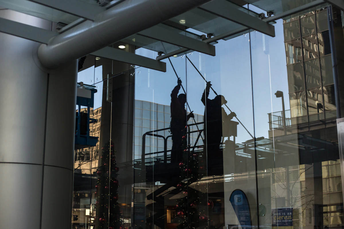 Window cleaner on a lift cleaning upper windows