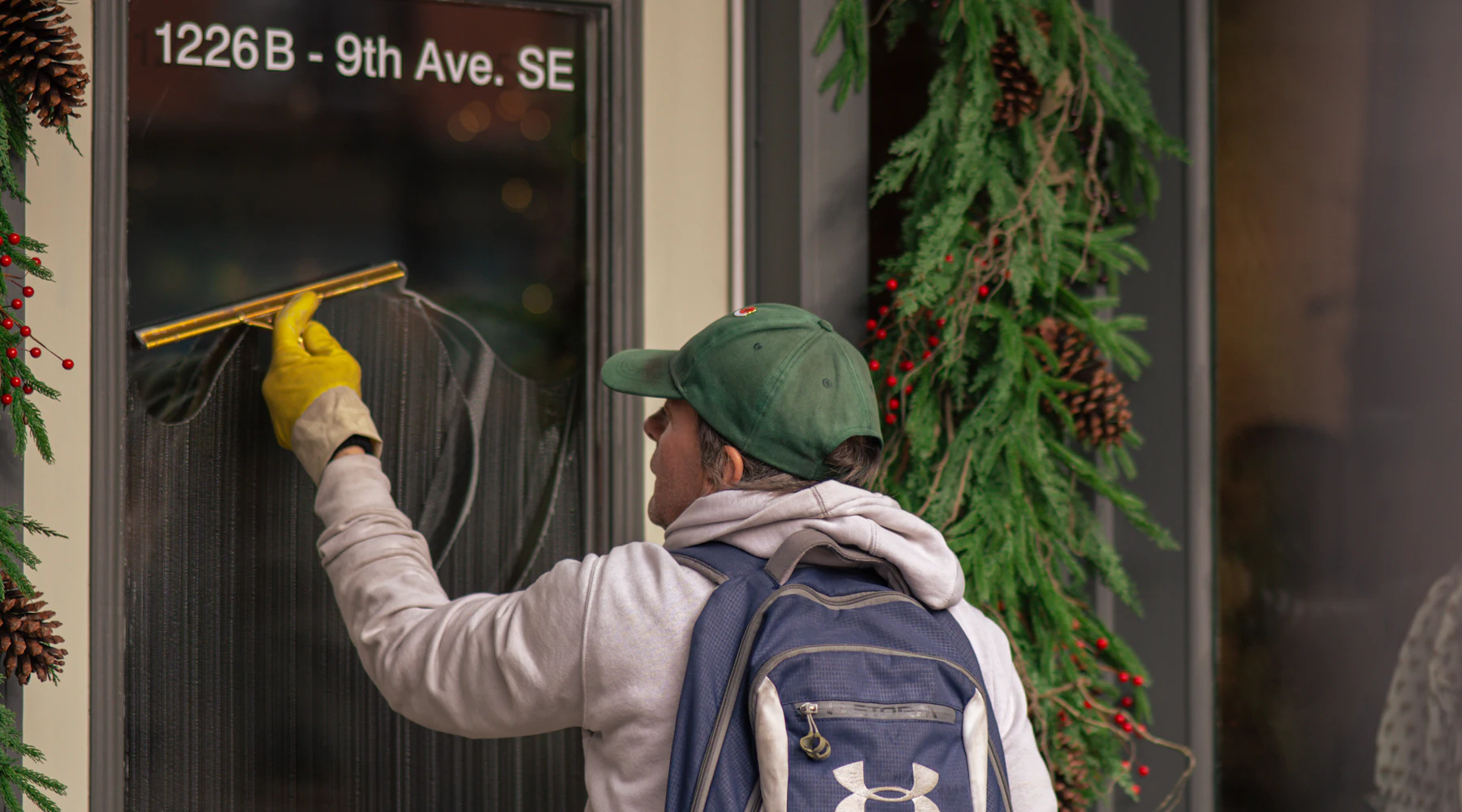 Window cleaner using a squeegee on glass