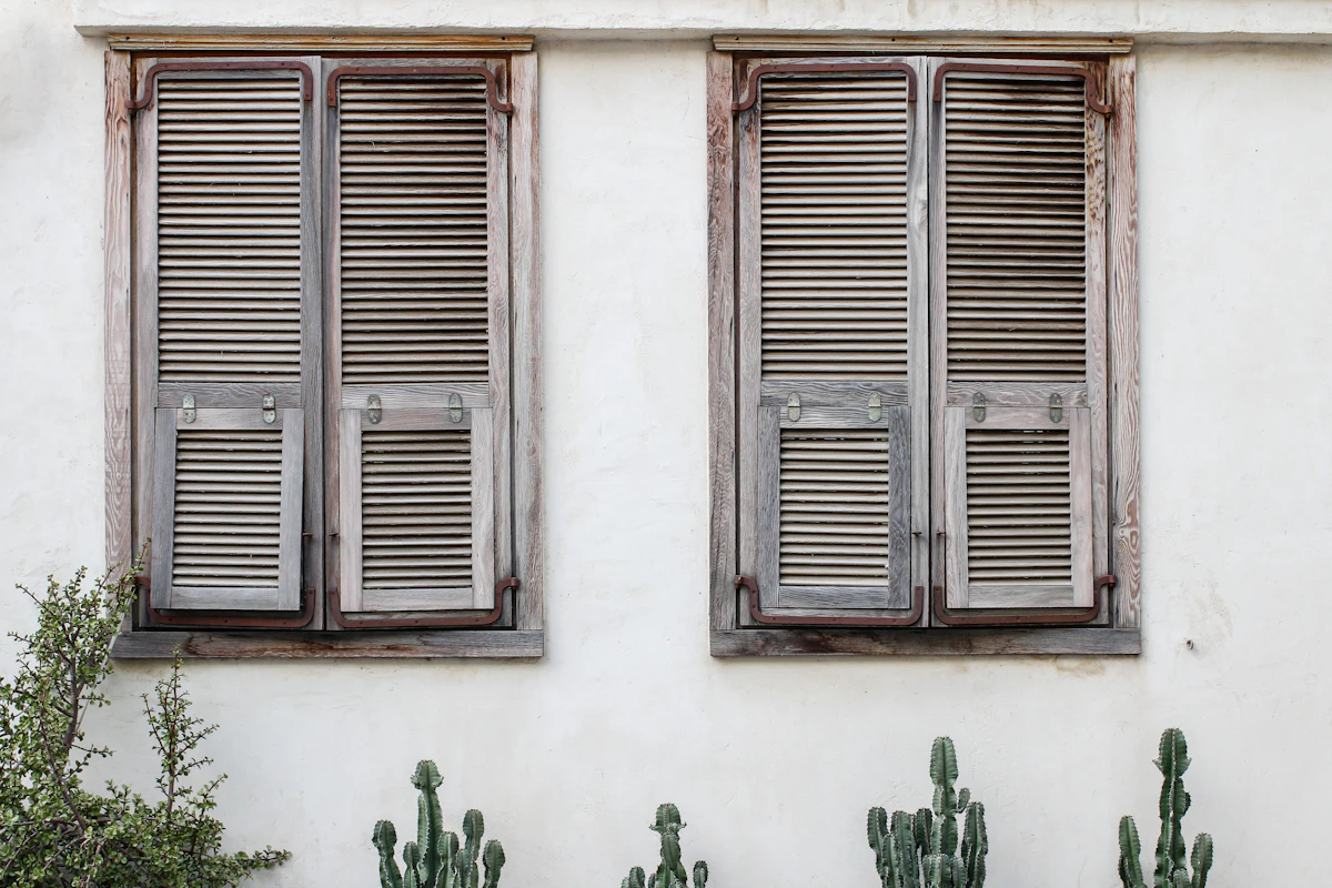 Modern black-framed window in a white stucco wall